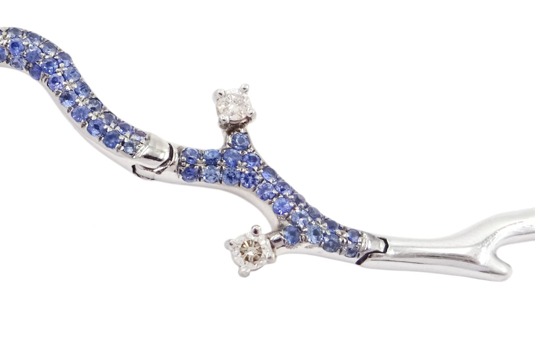 18ct white gold gemstone set floral jewellery suite, comprising necklace, pair of earrings and bracelet, each with tourmaline flower petals, round brilliant cut diamond centres and sapphire stems, stamped