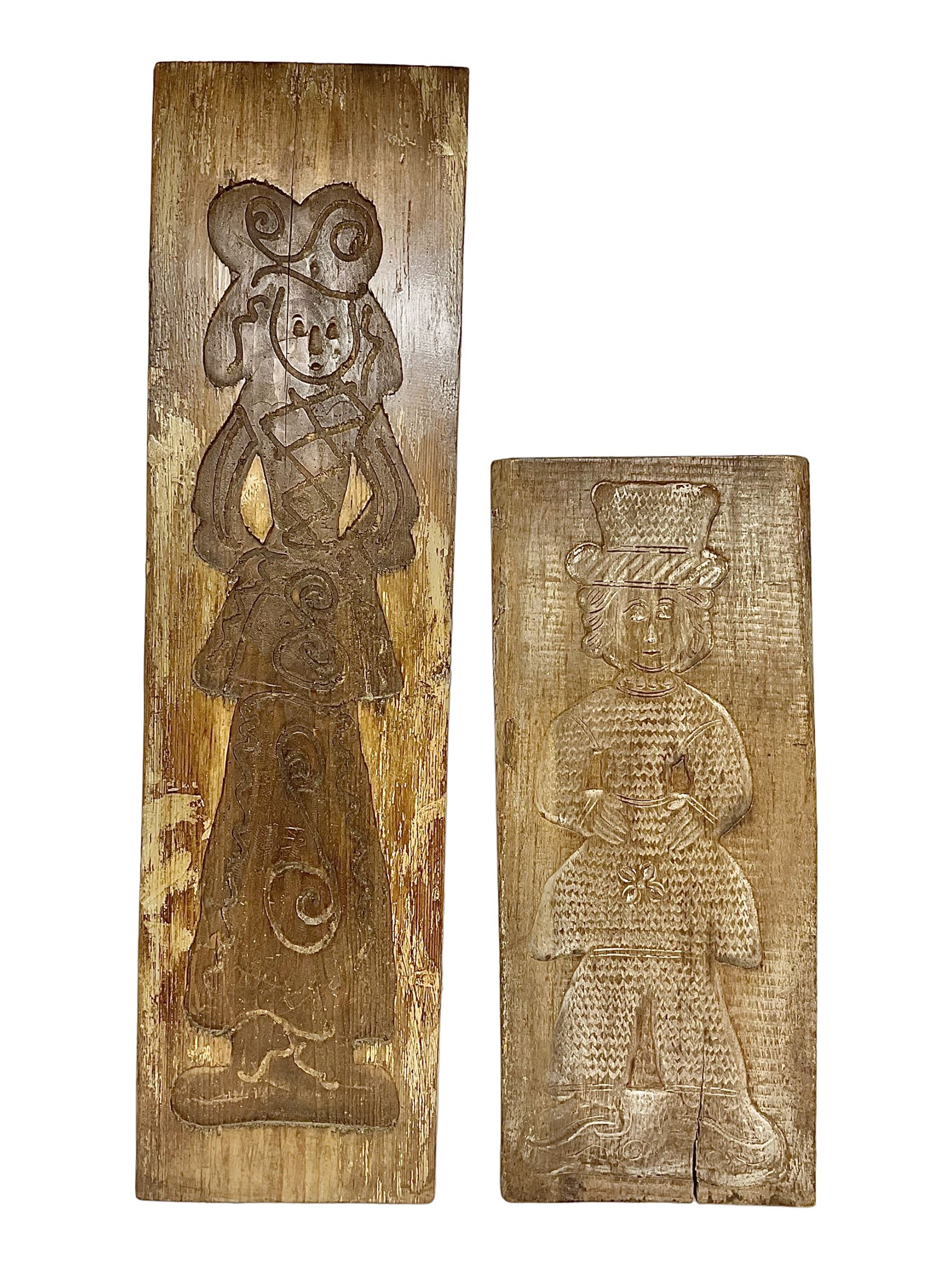 Two 20th century hardwood Dutch folk art Speculaasplank or biscuit moulds, typically carved with figures in traditional dress, largest H101cm