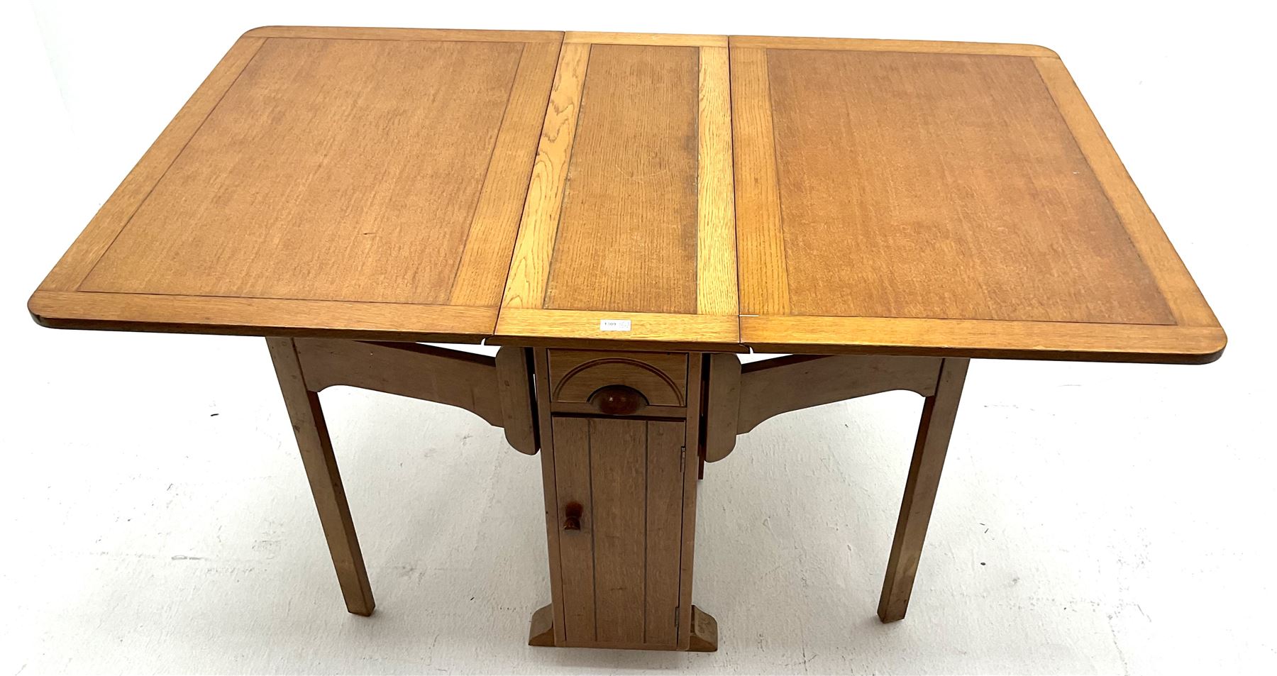 Harris Lebus style oak drop leaf table, two drawers and two cupboards 