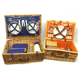  Two wicker picnic baskets, the largest by Optima and fitted for four people, the smaller unmarked and fitted for two, largest when closed H20cm L56 D38.  