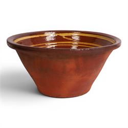 19th century terracotta bread pancheon, of circular form, the glazed interior with slip de...