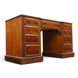 Victorian mahogany inverse breakfront twin pedestal desk, inset leather top over central drawer, flanked by pedestals with four graduating drawers, raised on a plinth base