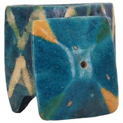 Raqqa ware pottery model of a monkey, probably Assyrian, modelled in crouching position, with turquoise and blue glaze, H6cm, together with a Raqqa ware pottery pot, also probably Assyrian, of square sided form, twin lug handles and canted cover, upon four tapering feet, decorated with yellow and green zig-zag bands upon a turquoise glazed ground, H8cm