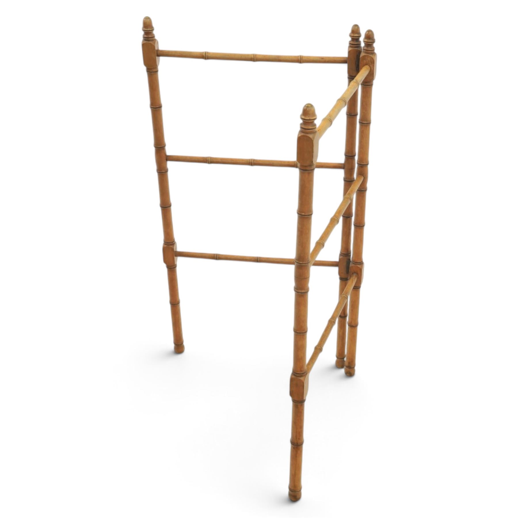 Victorian simulated bamboo two section towel rail, with turned brass capped finials, with three rails for hanging, hinged at one side