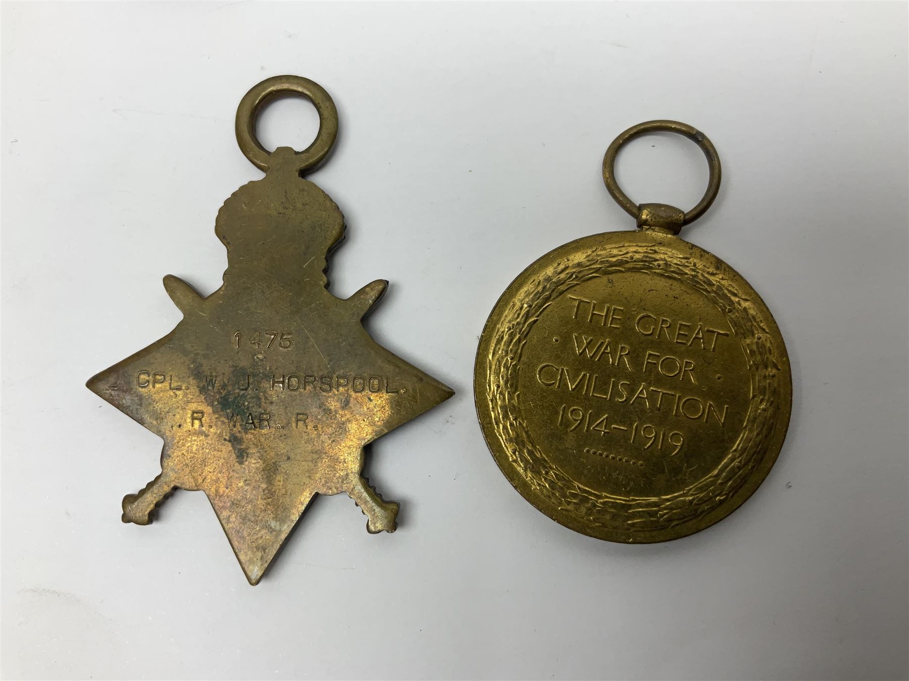 WW1 group of three medals comprising 1914-15 Star awarded to L-Cpl. W.J. Horspool R.War.R., British War Medal and Victory Medal awarded to A. Cpl. W.J. Horspool R.War.R.; WW1 British War Medal awarded to 3-8755 W.O.Cl.2. S. Paterson North'd Fus.; and hallmarked silver and enamel Northumberland Football Association Junior Cup Runners Up fob 1921-22 on silver chain (5)