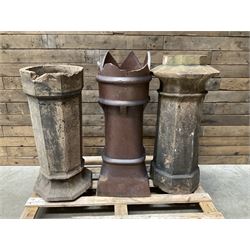 Collection of three Victorian and early 20th century reclaimed terracotta chimney pots, comprising: one cylindrical form with weathered, cracked glaze and flared octagonal base; one deep red cylindrical pot with fluted midsection and castellated rim, bearing moulded number ‘25’; and one tapering hexagonal example with wide flared rim and weathered patina. All with age-related wear and chips, consistent with use and outdoor exposure. Plus a selection of cast stone pieces including fountain 