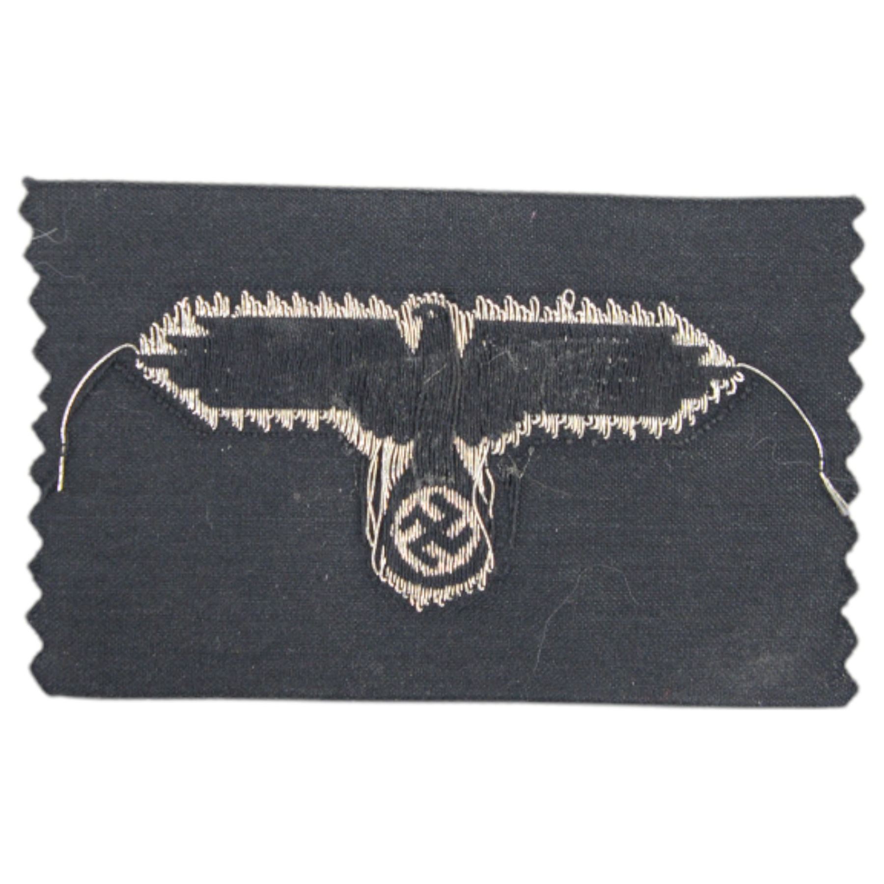 Third Reich SS officers cap insignia, machine-woven silver bullion SS Eagle, on black rectangle, together with German Eastern Front Medal, insignia H5cm, L7cm 