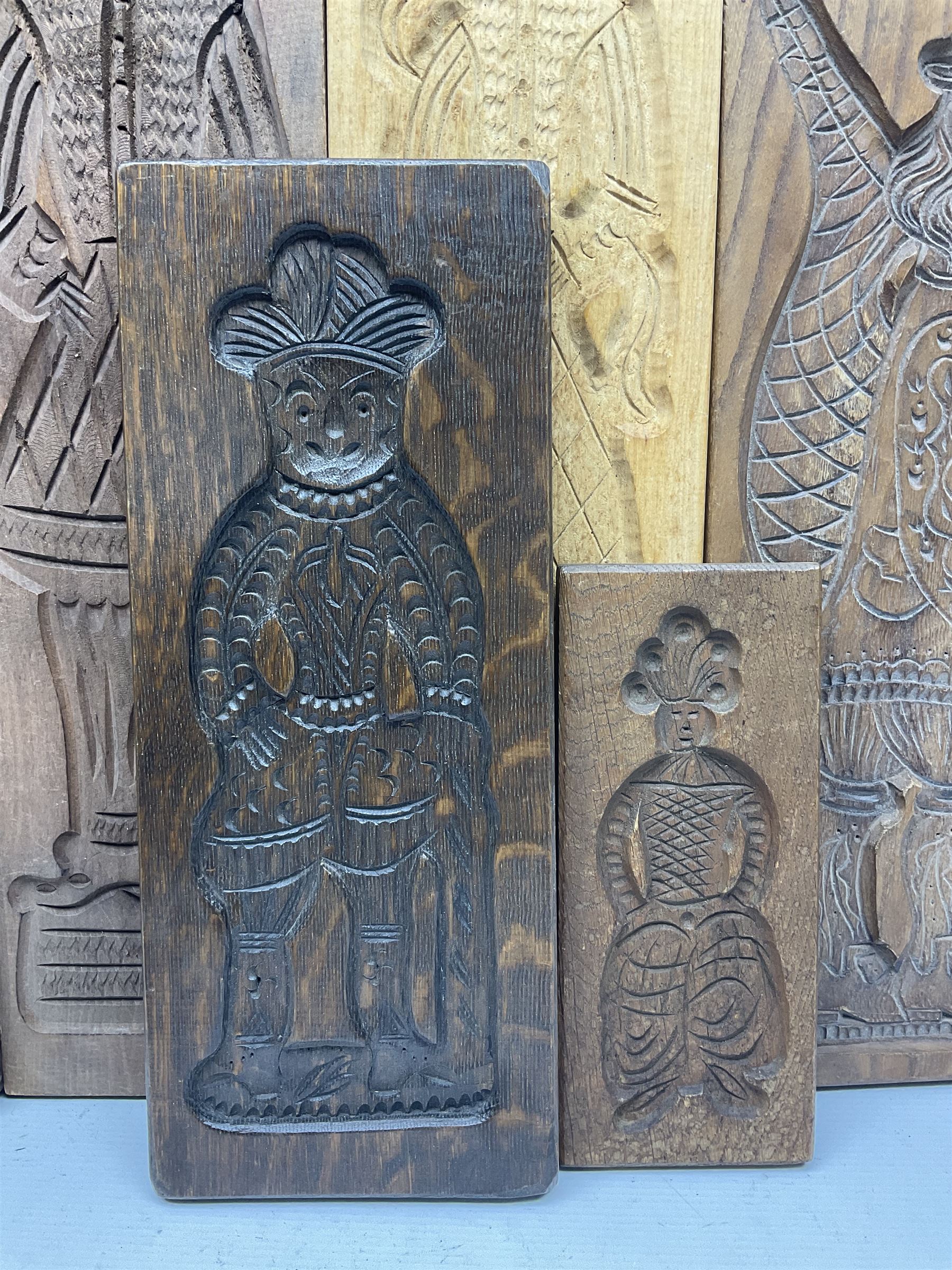 Eight 20th century hardwood Dutch folk art Speculaasplank or biscuit moulds, most examples typically carved with figures in traditional dress, tallest H60cm