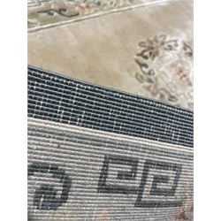 Chinese washed woollen camel ground rug, circular medallion surrounded by scrolls, the border decorated with birds and trailing floral decoration (248cm x 155cm); Chinese washed woollen pale green ground rug (125cm x 69cm); Persian design rug (186cm x 121cm) (3)