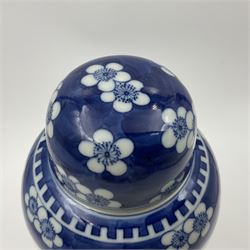Late 19th century Chinese blue and white jar and cover, of slender ovoid form with domed cover, decorated with two reserves containing figures, against a prunus blossom ground, with Kangxi type mark beneath, H27.5cm