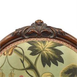 Small Victorian mahogany nursing chair, with carved top rail above a padded balloon back and shaped seat upholstered in light green fabric detailed with exotic birds and flowering vines, raised upon cabriole front legs and turned rear supports