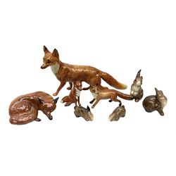 Collection of Beswick figures to include recumbent fox no.1017, standing fox, probably Beswick no.1016a, two other smaller Beswick fox figures, and four Beswick rabbit figures modelled as rabbits to include no.824, no.825 and no.823 (8) 