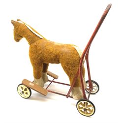 Pedigree push along plush covered horse 1950s-60s with red tubular metal framework and beech foot rests H25