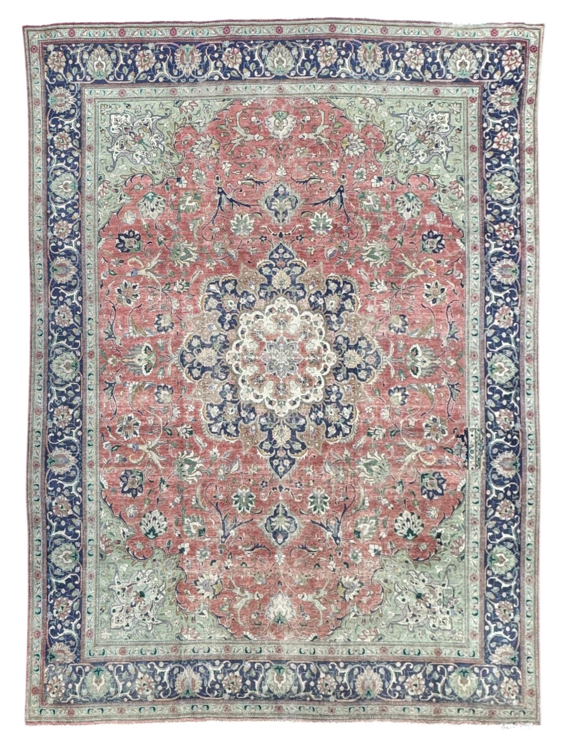 Persian rose ground rug, large central floral medallion surrounded by scrolling foliate and floral motifs, pale green spandrels, wide border in pale green and navy with intricate floral designs, framed by multiple guard stripes with repeating floral and geometric patterns