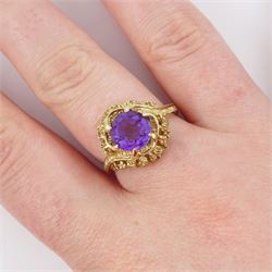 9ct gold amethyst single stone ring, round cut amethyst set within a pierced textured surround, London 1972