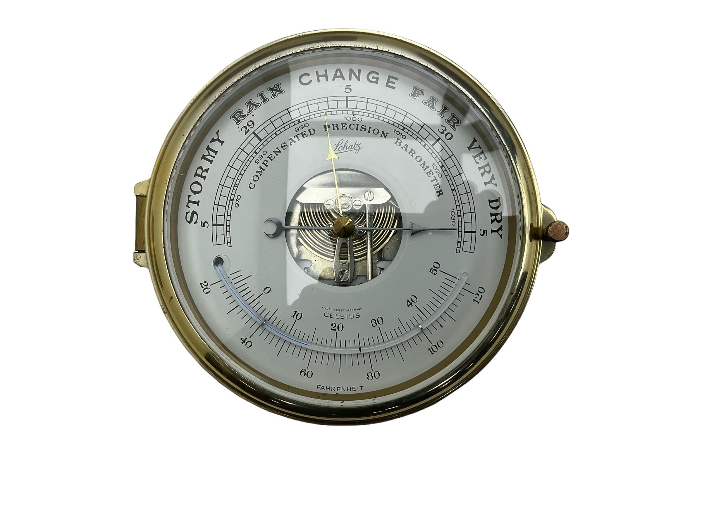 Eight-day 20th century brass cased “Schatz Royal Mariner” bulkhead clock, with a 6” dial, Roman numerals and minute track, bells on/off control, black spade hands with a brass bezel and flat bevelled glass, twin train spring driven balance wheel movement sounding the ships watches on a bell.
With a corresponding and matching Schatz open dial compensated aneroid barometer, with weather predictions and measuring barometric pressure in inches and millibars, with a curved spirit thermometer measuring temperature in Fahrenheit and Celsius, steel indicating hand and brass recording hand.
