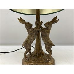 Composite table lamp, modelled as a pair of boxing hares, with a green velvet shade, H45cm