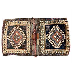 Antique Persian red ground saddle bag, decorated with all-over Boteh motifs, geometric patterned border (127cm x 68cm); Persian indigo ground saddle bag, decorated with two geometric ivory lozenges (113cm x 62cm); Persian red ground saddle bag decorated with lozenges and multi-band border (110cm x 65cm) 