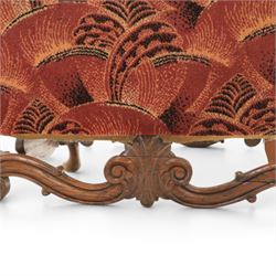 Large upholstered wingback chair, crimson geometric upholstery, carved front apron raised on cabriole supports 