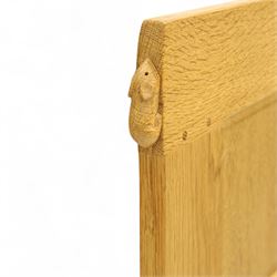 Mouseman - single bed oak headboard, comprising eight vertical fielded panels beneath a shaped and scalloped top rail, carved with the signature mouse motif, by the workshop of Robert Thompson, Kilburn 