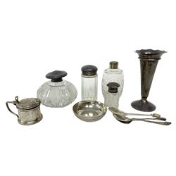 Group of silver, comprising trumpet vase with weighted base, hallmarked Mappin & Webb Ltd, Birmingham 1923, mustard pot and cover, hallmarked Docker & Burn Ltd, Birmingham 1922, with blue glass liner, a Persian silver dish set with coin, four cut glass bottles with silver collars and lids, two silver spoons and a silver plated spoon 