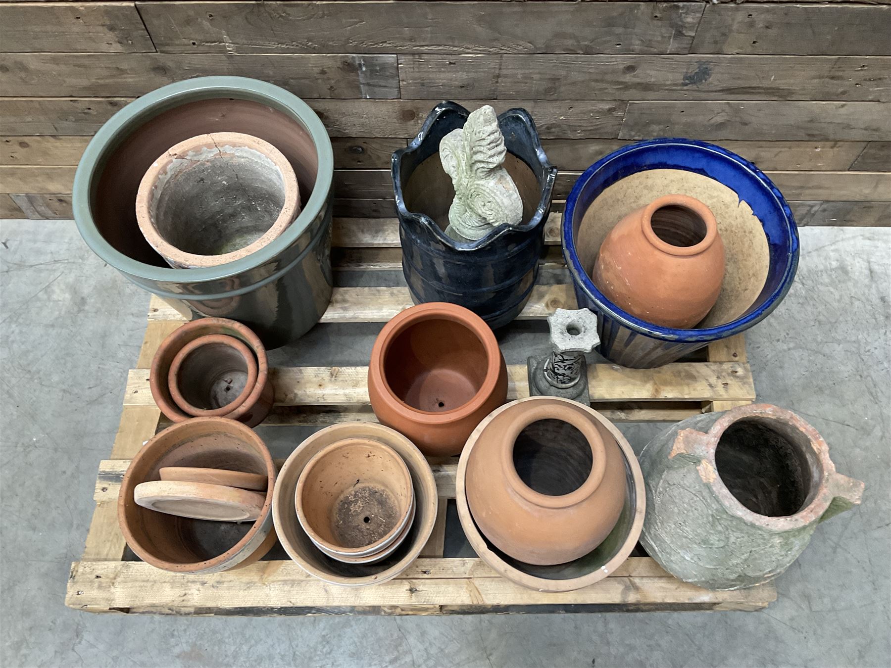A quantity of various terracotta and glazed planters