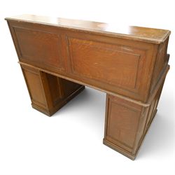 Cutler - Late Victorian oak pedestal tambour desk, the tambour shutter enclosing fitted interior, pull-out writing surface over central kneehole flanked by two pedestals each fitted with four drawers with moulded fronts, pull-out slides above, panelled sides, on moulded plinth base