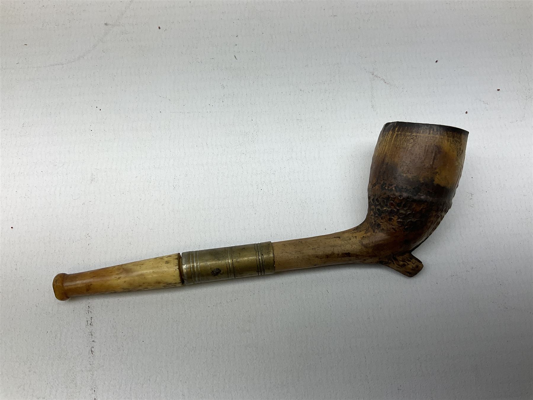 Carved meerschaum and amber pipe with silver mount, the bowl carved as a woman, cased, clay pipe in the form of an acorn, ceramic pipe, five other pipes and a ceramic bottle pourer in the form of a horse  