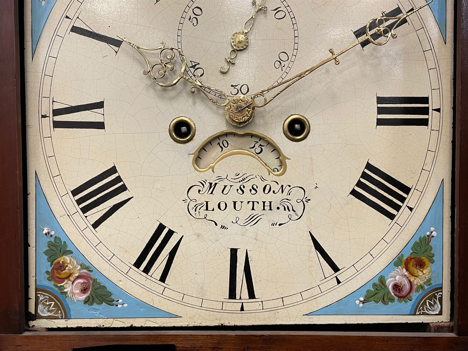 Musson of Louth - mid-19th century oak and mahogany 8-day longcase clock, with a swan’s neck pediment and ball and spire brass finial, break arch hood door flanked by reeded pilasters with brass capitals, canted angled trunk, flat topped door with concave corners, rectangular plinth on bracket feet, fully painted break arch dial with Roman numerals and minute track, subsidiary seconds dial and calendar aperture, matching stamped brass hands, eight day rack striking movement with anchor escapement. With weights and pendulum.
H206 W44 D23
Balthazar Musson from Baden (Germany) is recorded as working in Louth from 1835, naturalised 1861-8. Succeeded by his son, George Balthazar 1872-1920. 
