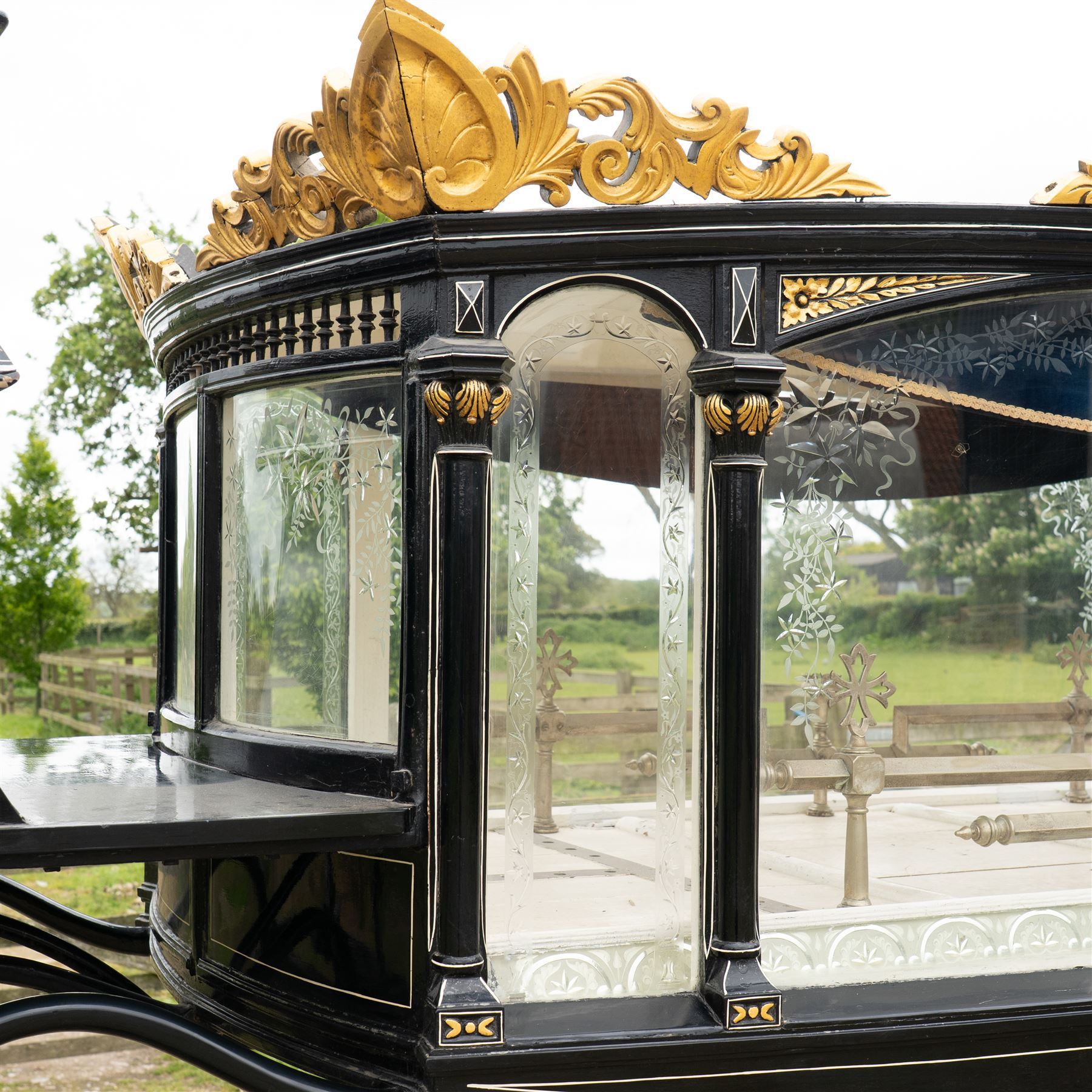 Victorian Glass Hearse

A black painted four wheeled horse drawn glass hearse with extensively glazed coffin compartment, etched glass side and end panels, decorative gilt cresting, gilt column capitals, white painted interior bier deck, metal coffin rails with cross finials, rear glazed access doors, external coachman's box seat for two, wooden spoked wheels the wheel hubs stamped 'The Economic Funeral Co', leaf spring suspension, underbody turntable steering and pole for driving with a pair of horses. The hearse has decorative painted lining throughout and an ornate black and gilt body with curved glass panels to the sides and rear.

Features

• Extensively glazed coffin compartment
• Etched glass side and end panels
• Decorative gilt cresting
• Gilt column capitals
• White painted interior bier deck
• Metal coffin rails with cross finials
• Rear glazed access doors
• External coachman's box seat
• Wooden spoked wheels
• Leaf spring suspension
• Underbody turntable steering
• Pole for driving with a pair of horses
• Decorative painted lining

Dimensions:
Overall length: 406 cm
Body length: 250 cm
Overall width: 190 cm
Body width: 115 cm
Height: 228 cm

Wheel Diameters:
Front wheels: 102 cm
Rear wheels: 133 cm

Seating

Coachman's box seat: 2