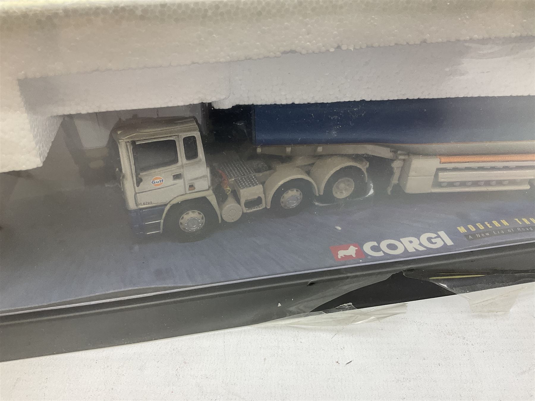 Three Corgi 1:50 scale lorries - ERF Tanker - Gulf Oil in perspex display case No.75101; limited edition Scania T Bulk Tipper - Maguires of Cheltenham No.CC12803; and Scania Topline Curtainside - Stephen Sanderson Limited No.CC12912; all boxed (3)