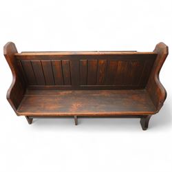 Victorian pine pew or bench, panelled back with book raised over plank seat, on shaped end supports united by stretcher 