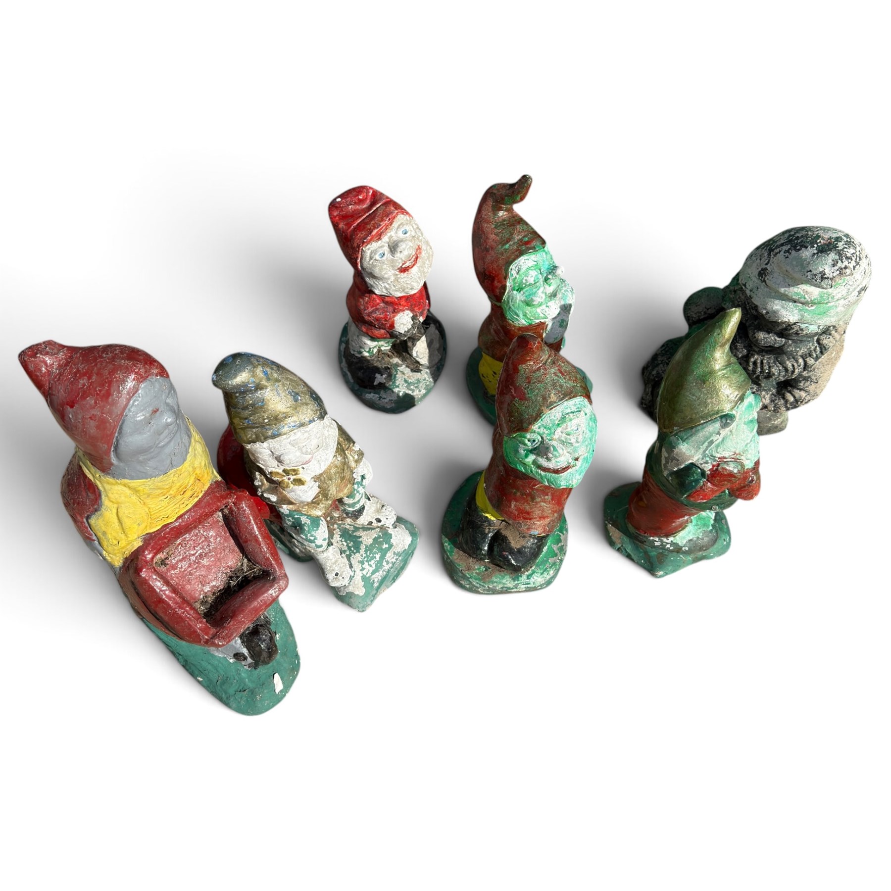 Bronzed composition figure of a seated French bulldog, together with a collection of vintage painted cast stone garden gnomes