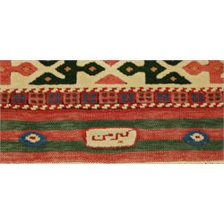 Anatolian Soumak rug, ivory ground decorated with a grid of eight octagonal medallions in terracotta red outlined in blue, centered with a star motif in vertical rows, framed by a series of geometric borders in ivory, green, and blue, incorporating hooked devices and stylized lozenges and stripped end panels, with signature at either end 
