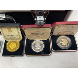 The Royal Mint United Kingdom 1977 silver proof two coin set, Queen Elizabeth II 2002 silver proof three coin set, comprising Bailiwick of Jersey, Bailiwick of Guernsey, and Alderney five pound coins, 'First Coinage of the British Virgin Islands' proof set, 1997 1/10 ounce fine silver Britannia, two King George V 1935 'Rocking Horse' crowns, various Isle of Man commemorative crowns, etc., house in a hard shell carry case