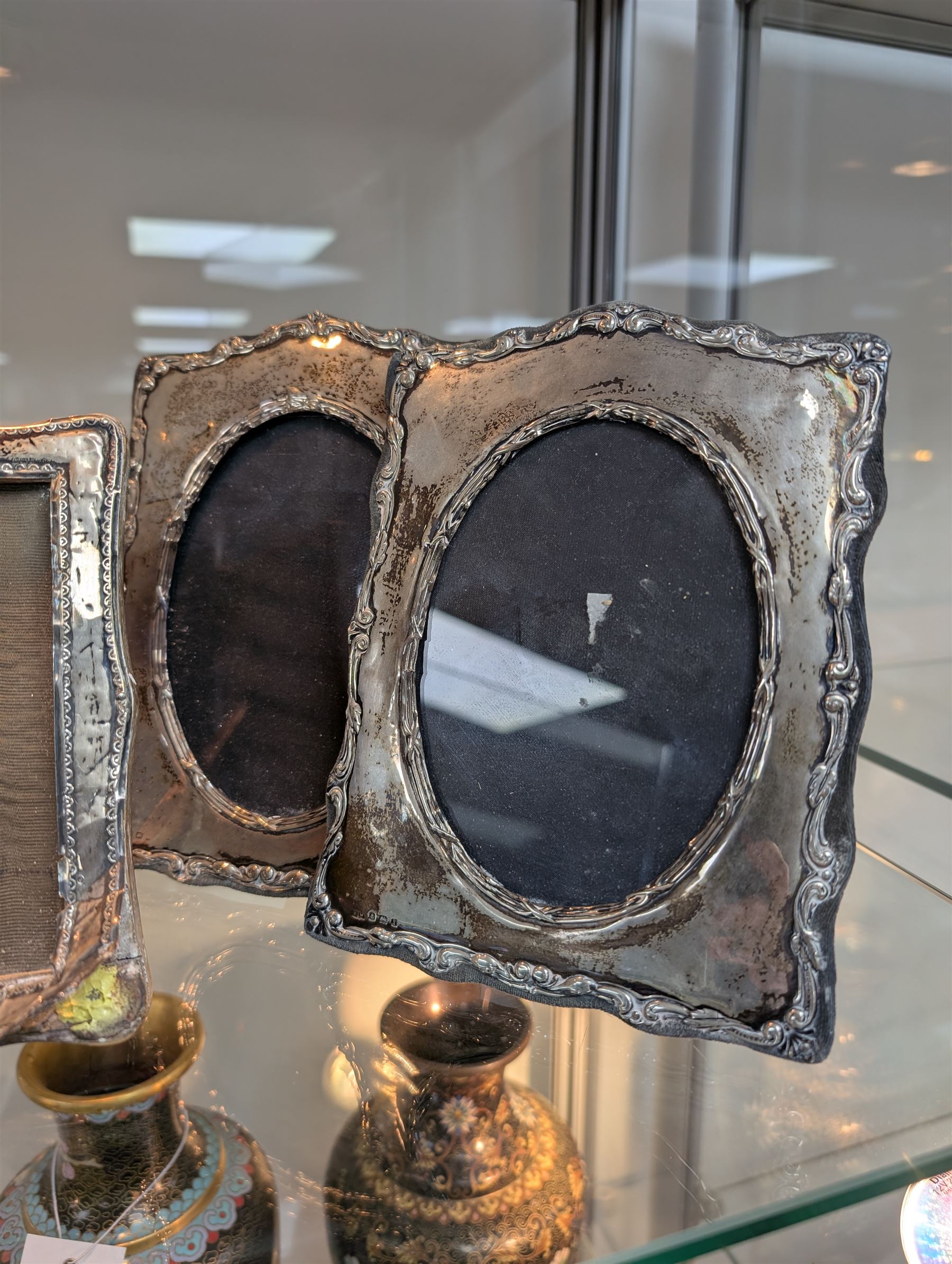 Four silver mounted photograph frames, including Edwardian pair with C scroll and reed and ribbon borders, hallmarked Henry Matthews, Birmingham 1908, tallest H18cm
