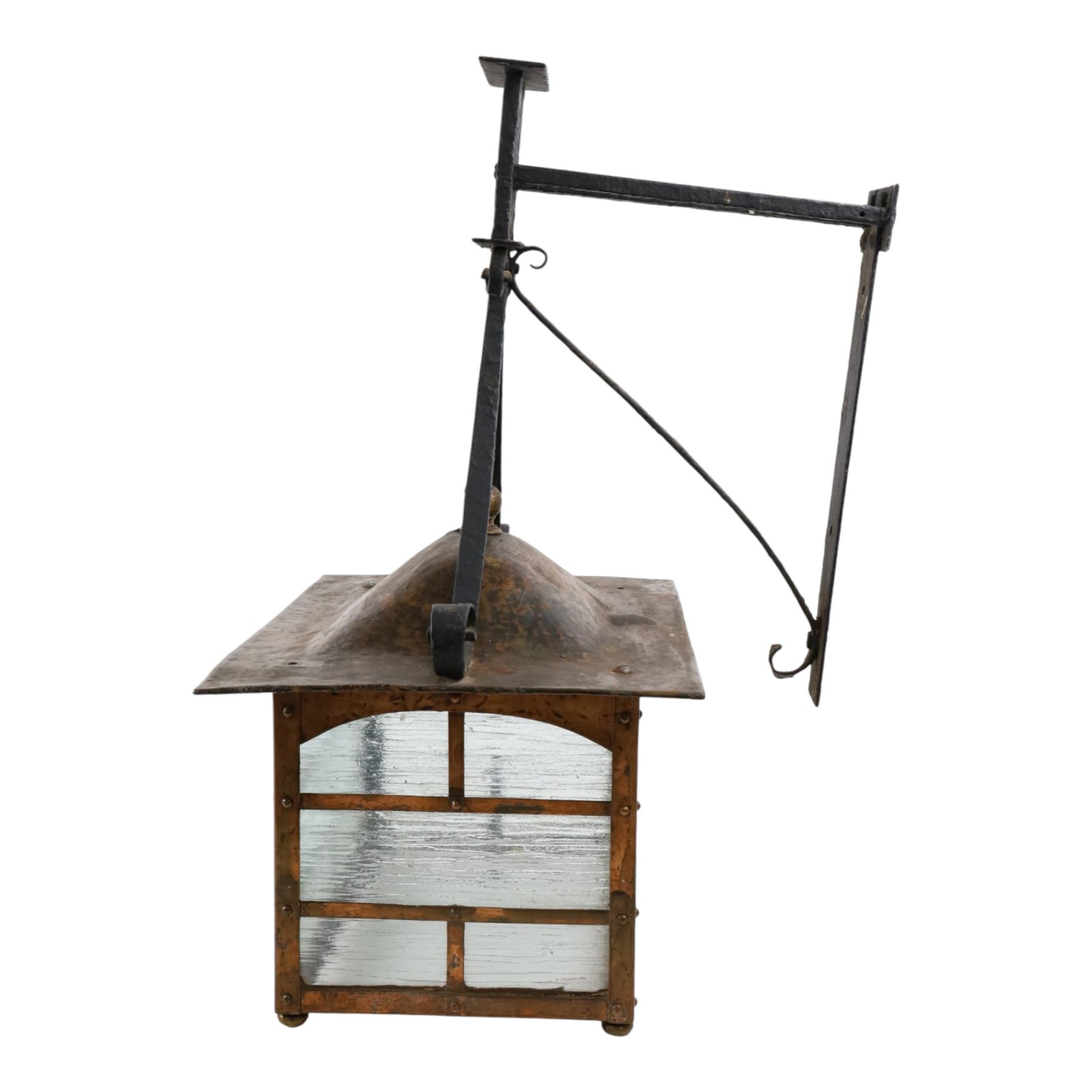 20th century, Arts and Crafts style copper porch lantern, of rectangular form, with cast iron scrolling wall fittings