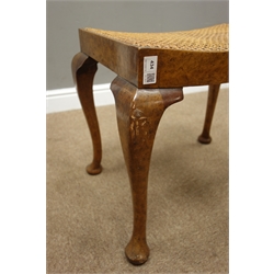  20th century walnut dressing table stool, dished cane work seat, on cabriole supports, W55cm  
