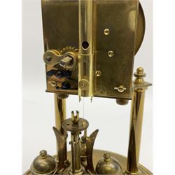 A German torsion pendulum clock by  Jahresuhrenfabrik (August Schatz & Söhne), Triberg, Germany, early 20th century with a 2-3/4-inch cream enamel dial within a spun bezel, upright Arabic numerals with minute track and steel spade hands, 400-day spring driven movement with a four-ball rotary pendulum, clear glass dome on a  20cm circular brass effect base.
Height 32cm 
