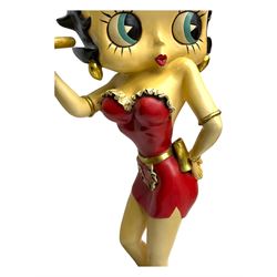 Contemporary Betty Boop waitress figure, modelled standing with one hand holding a circular tray, dressed in a red dress with gold accents, on a black circular base