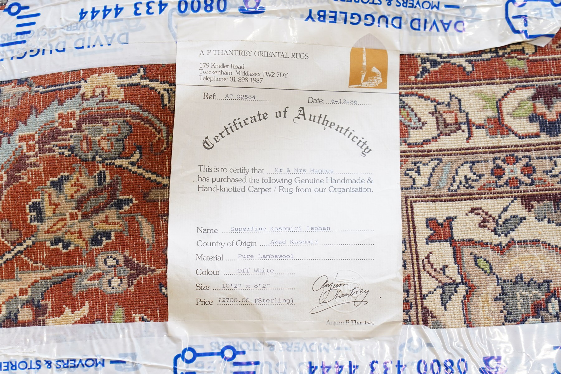 Persian ivory ground Kashan carpet, the busy field decorated with a central floral pole medallion with matching spandrels, the field profusely decorated with scrolling foliate motifs, the crimson guard stripe with repeating scrolling palmettes