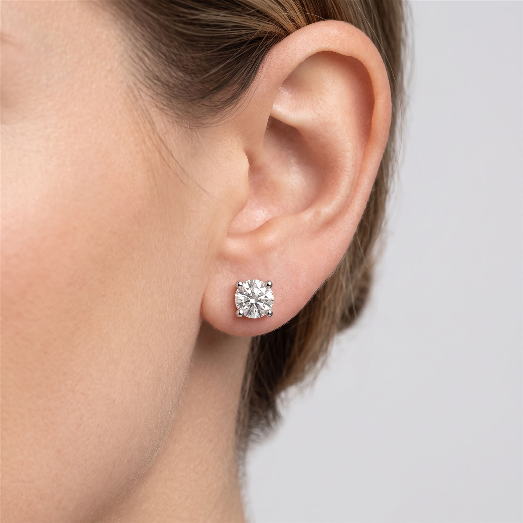 Pair of platinum diamond earrings, each stud set with a single round brilliant cut diamond, stamped PT 950total diamond weight approx 1.05 carat
