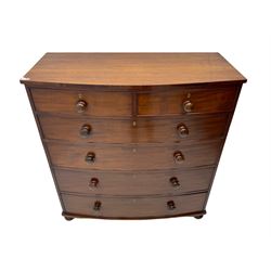 19th century mahogany bow-front chest, fitted with two short over four graduating long drawers, each with cock-beaded facias and turned wood handles, raised on bun feet