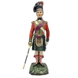 Sitzendorf figure, The Black Watch officer, c1815 standing to attention in full dress with sword, blue factory marks beneath, H28cm