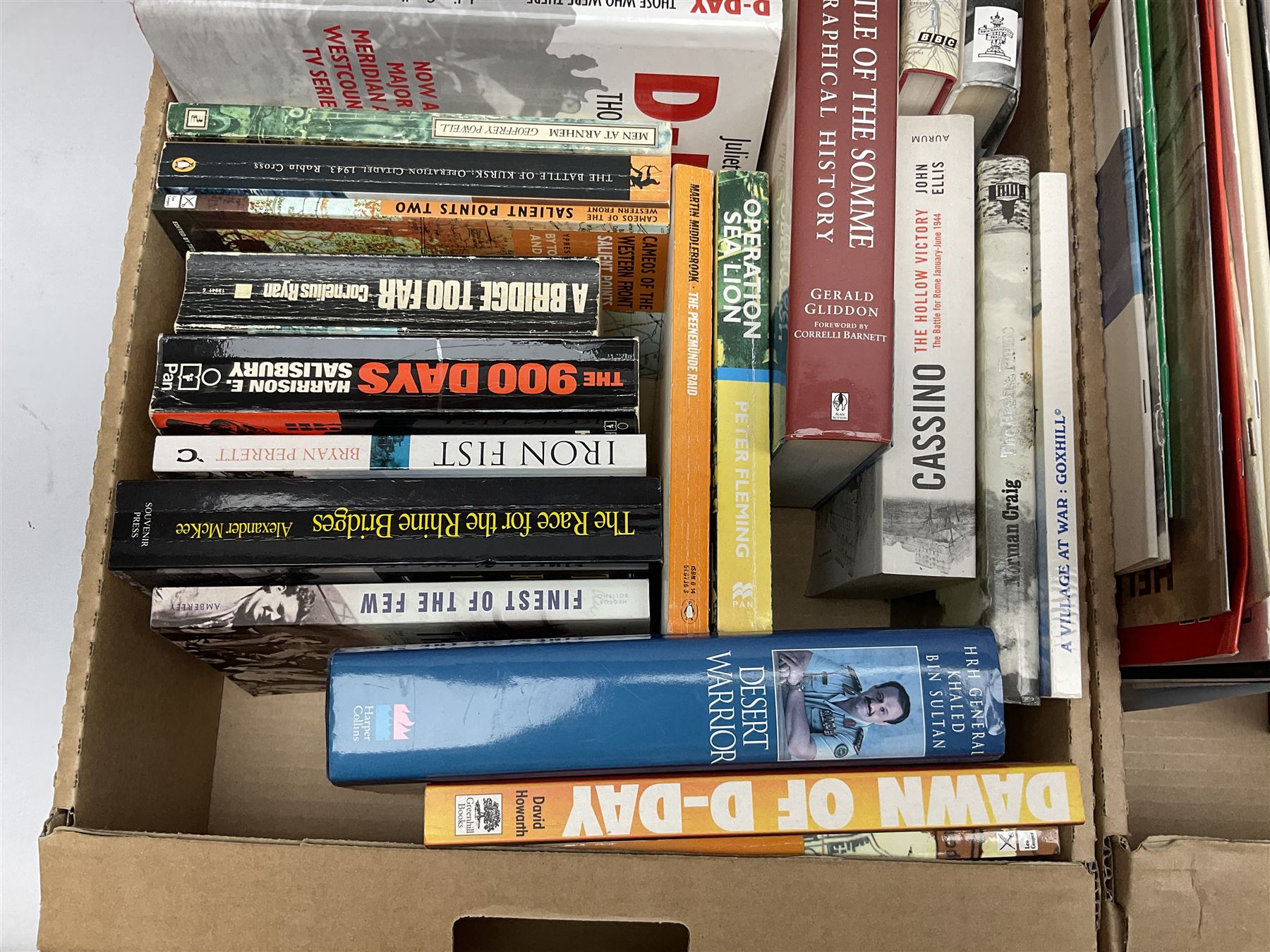 Large collection of hardback and paperback books, mainly military books, to include Band of Brothers, Dawn of D-Day, Dessert Warrior, Book of the Somme, Battle of Britain, etc in four boxes  