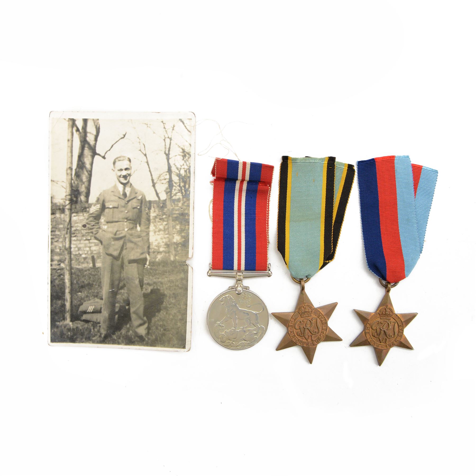 WWII trio of medals, comprising Defence Medal, 1939-1946 Star, Air Crew Europe Star, awarded to R.V Baker Esq, in original medal box, together with a photograph   