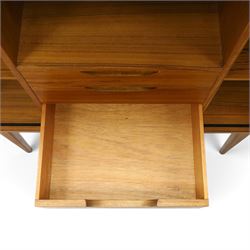 Alfred Cox - mid-20th century teak cabinet, rectangular top over two bifold doors with inset handles, opening to reveal three central graduating drawers surrounded by assorted shelves, raised on tapering supports united by H-stretcher, stamped to inside of drawer