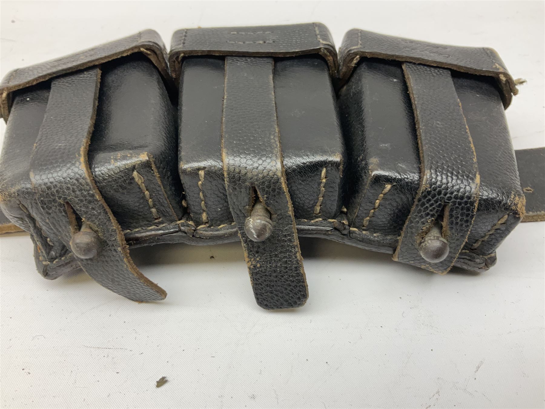 WW2 German 'SS' leather belt with six pouches (one containing unused field bandage) and buckle inscribed 'Meine Ehre Heifst Treue'; belt marked 0/0836 0029