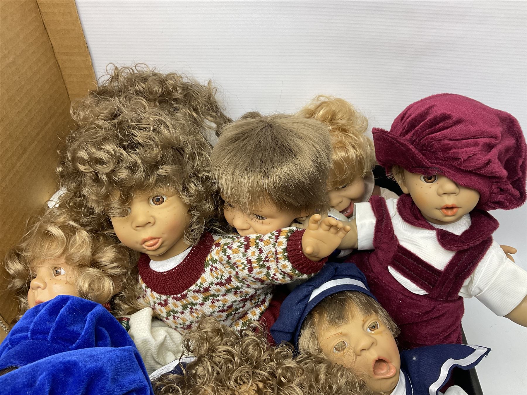 Quantity of vintage and later dolls to include unusual three faced example and further dolls marked C.J, Gloobee, Rosebud etc in three boxes