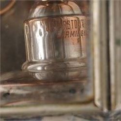 J Marston & Co. Ltd. (Birmingham) - pair of Victorian copper glazed and white metal carriage lamps with toleware outer-body, hexagonal body with faceted bevelled glass and reflective panels one inset with circular red reverse light, surmounted by a turned copper finial over a pagoda form chimney, raised on turned copper spoke, maker engraved to candle mount
